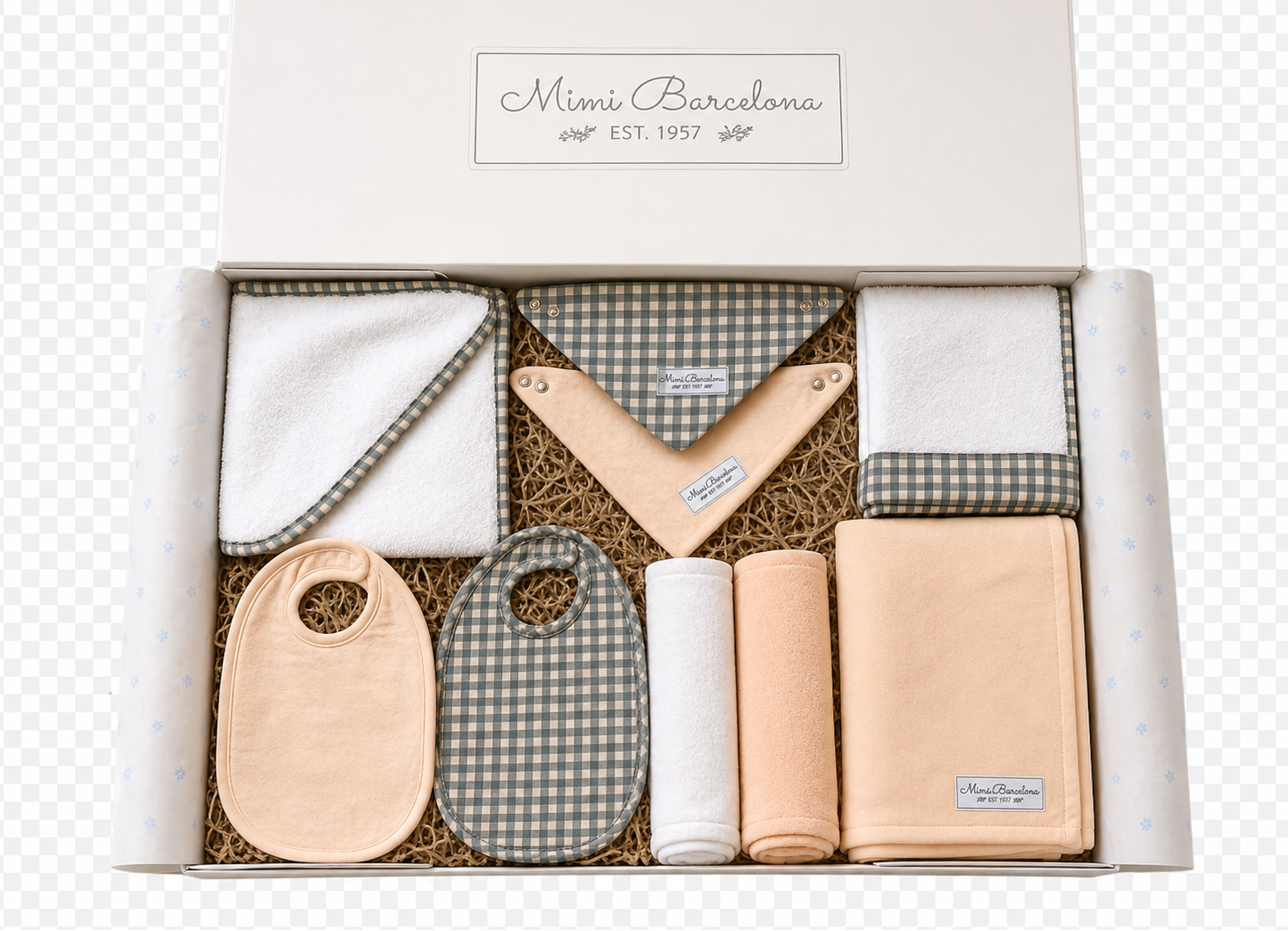 A baby gift set in a white box with the brand name 'Mimi Barcelona' printed on the lid. The set includes a white and green gingham bib, a peach-colored bib, a white and green gingham wrap, a peach-colored wrap, a white roll, and a peach blanket, all arranged on brown paper filler.