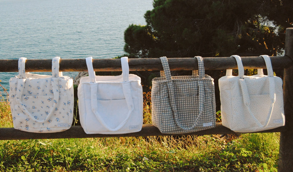 Different diapers bags infront of the Mediterranean sea