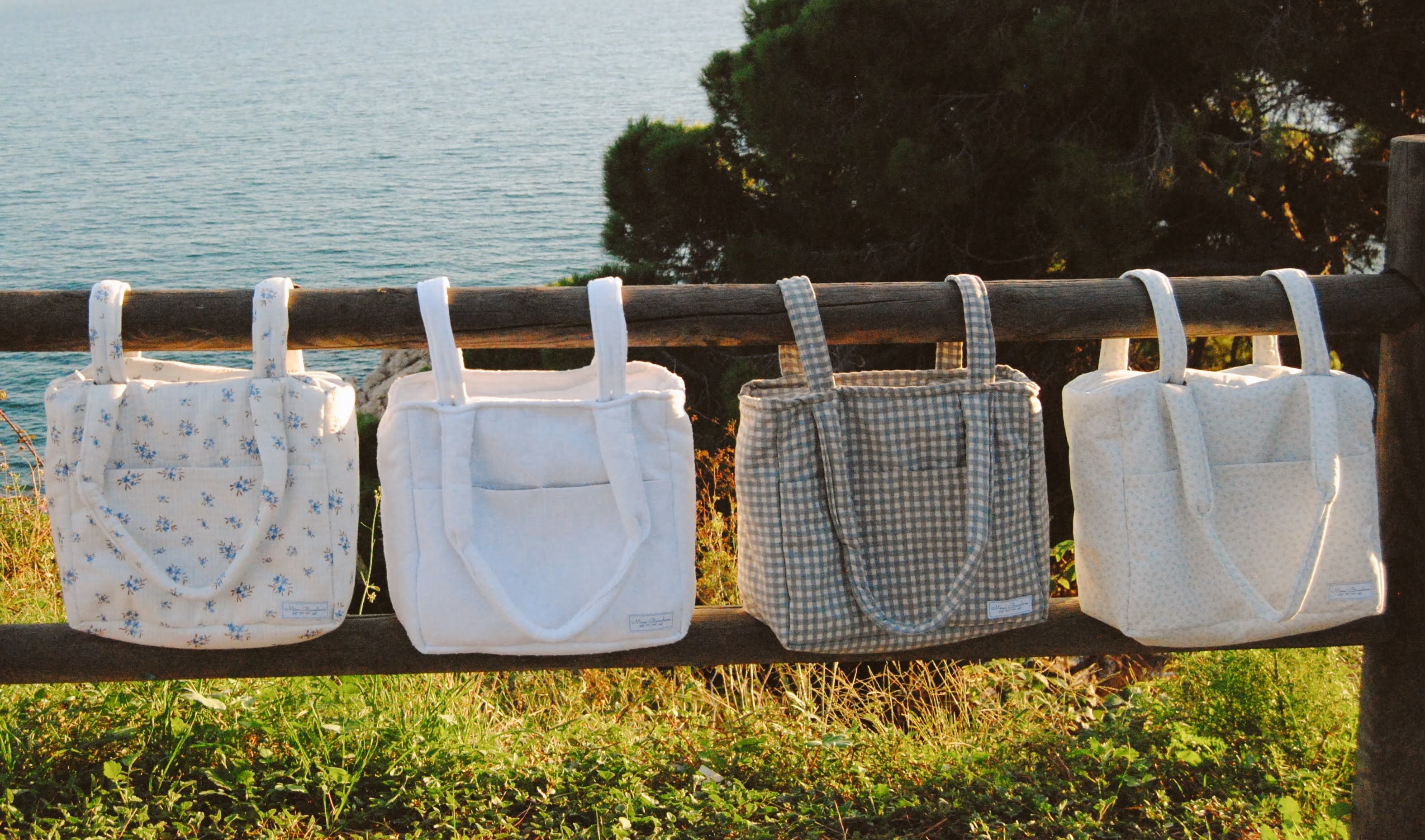 Different diapers bags infront of the Mediterranean sea